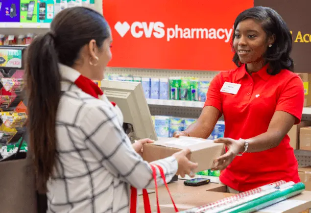 Customer is returning her products to CVS employee